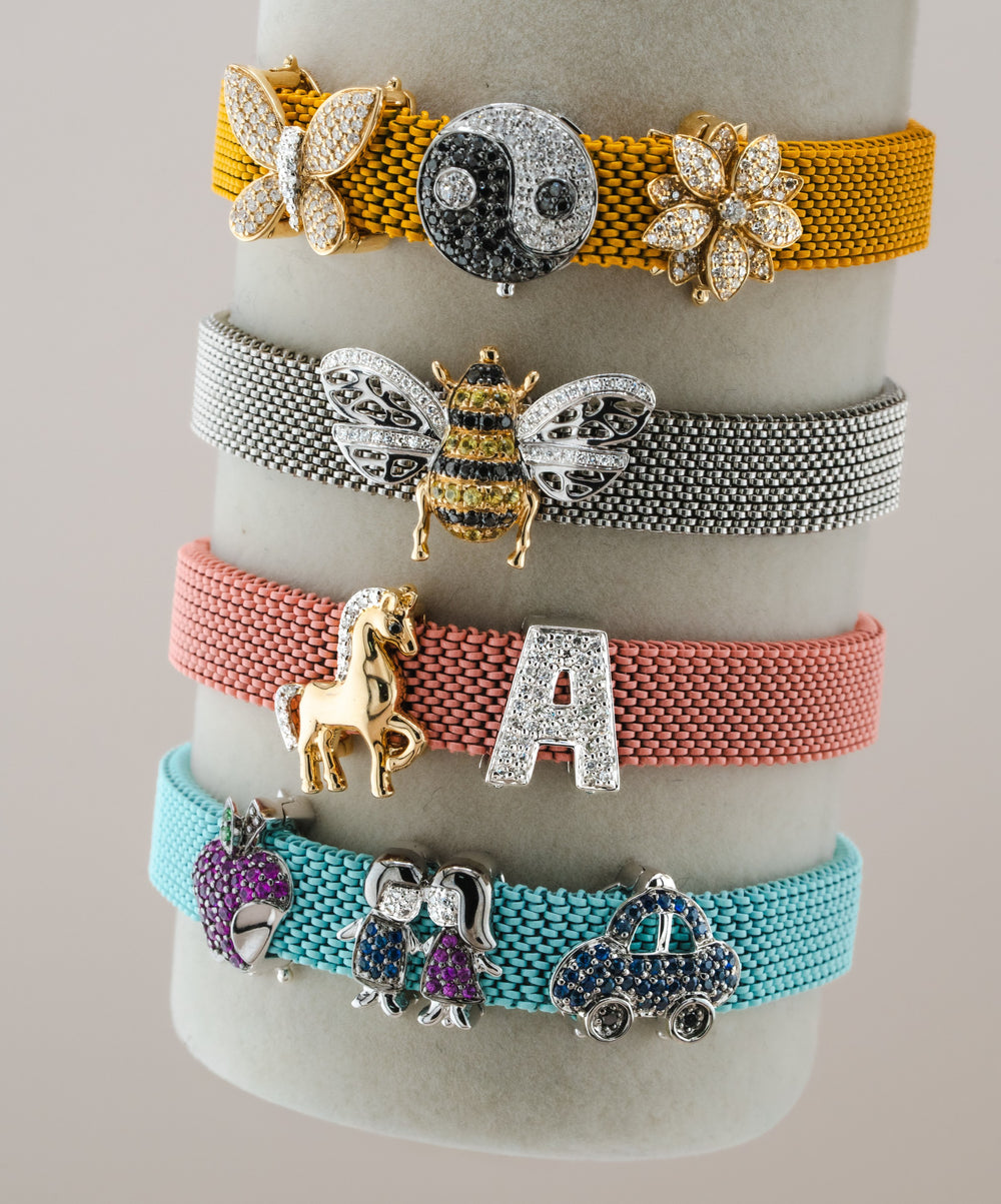 Four D'ORO charm bracelets in gold, silver, pink and turquoise