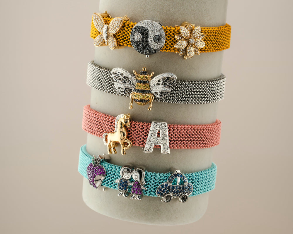 Four D'ORO mesh charm bracelets in gold, silver, rose and turquoise with diamond charms
