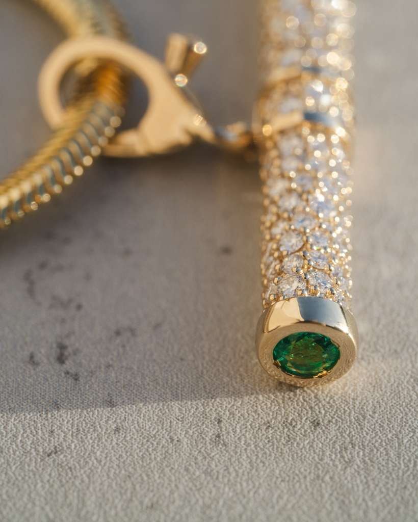 D'ORO diamond pave gold piece with an emerald